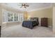 A sunny bedroom featuring a bay window, neutral carpeting, and an elegant, upholstered bed at 664 Oxbow Dr., Myrtle Beach, SC 29579
