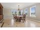 Traditional dining room with large windows, chandelier lighting, and classic furnishings at 664 Oxbow Dr., Myrtle Beach, SC 29579