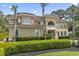 Elegant home with lush landscaping, a tile roof, and manicured hedges at 664 Oxbow Dr., Myrtle Beach, SC 29579