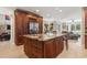 An expansive kitchen island boasts custom wood cabinets and granite counters with bar stool seating at 664 Oxbow Dr., Myrtle Beach, SC 29579