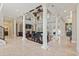 Spacious living room with high ceilings, stone columns, a fireplace, and a grand piano at 664 Oxbow Dr., Myrtle Beach, SC 29579