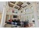 Open-concept living room with soaring ceilings, fireplace, hardwood floors, and stylish furnishings at 664 Oxbow Dr., Myrtle Beach, SC 29579