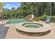 Backyard oasis featuring a pool, hot tub, and waterslide surrounded by lush landscaping at 664 Oxbow Dr., Myrtle Beach, SC 29579