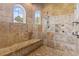 Elegant, tiled walk-in shower with bench seating and two windows for plenty of natural light at 664 Oxbow Dr., Myrtle Beach, SC 29579
