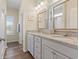 Bathroom featuring double sinks with granite countertops and white cabinets, plus a walk-in shower at 716 Weston Dr., Conway, SC 29526