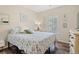 Comfortable bedroom with wood floors, floral bedding, and natural light from the window at 716 Weston Dr., Conway, SC 29526