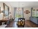 Charming dining area featuring a glass table, chandelier, hardwood floors, and blue patterned curtains at 716 Weston Dr., Conway, SC 29526