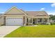 Charming single-story home featuring a two-car garage, inviting front porch, and manicured lawn at 716 Weston Dr., Conway, SC 29526