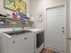 Bright laundry room with organized shelving and modern appliances at 716 Weston Dr., Conway, SC 29526