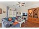 Cozy living room featuring a ceiling fan, hardwood floors, and built-in wooden shelving at 716 Weston Dr., Conway, SC 29526