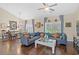 Open-concept living room with hardwood floors and a dining area featuring a glass-top table at 716 Weston Dr., Conway, SC 29526