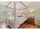 Serene bedroom featuring a four-poster bed, hardwood floors, and a marble topped nightstand at 716 Weston Dr., Conway, SC 29526