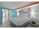 This spacious bedroom features a comfortable bed, beach-themed artwork, and modern bedside tables at 7200 N Ocean Blvd. # 459, Myrtle Beach, SC 29572