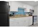 Bright kitchen with white cabinetry, granite countertops, and modern appliances at 7200 N Ocean Blvd. # 459, Myrtle Beach, SC 29572