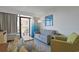 Inviting living room featuring a comfortable sofa, stylish decor, and access to a private balcony at 7200 N Ocean Blvd. # 459, Myrtle Beach, SC 29572