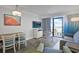 Well-lit living room with modern furnishings, including dining area and access to a private balcony at 7200 N Ocean Blvd. # 459, Myrtle Beach, SC 29572