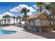 Exterior view of a poolside tiki bar, lounge chairs, and an ocean view at 7200 N Ocean Blvd. # 459, Myrtle Beach, SC 29572