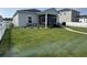 Manicured backyard with privacy fence, rock garden, and a screened porch at 8164 Forest Edge Dr., Myrtle Beach, SC 29579