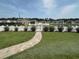 Lush backyard with a paver path leading to a white picket fence and community view at 8164 Forest Edge Dr., Myrtle Beach, SC 29579