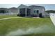 Large backyard with well-maintained green grass, landscaping, and a screened-in porch at 8164 Forest Edge Dr., Myrtle Beach, SC 29579