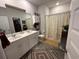 Bright bathroom with double vanity, linen closet, and shower with decorative curtain at 8164 Forest Edge Dr., Myrtle Beach, SC 29579