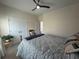 This bedroom includes a ceiling fan, patterned bedding, and natural light at 8164 Forest Edge Dr., Myrtle Beach, SC 29579