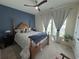 This bedroom features a dark accent wall and curtains that frame the window at 8164 Forest Edge Dr., Myrtle Beach, SC 29579