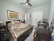 Cozy bedroom with a ceiling fan, framed art, matching nightstands, lamps and a comfortable quilt-covered bed at 8164 Forest Edge Dr., Myrtle Beach, SC 29579