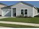 Charming one-story home with a white garage door, tidy lawn, and blossoming flowerbeds at 8164 Forest Edge Dr., Myrtle Beach, SC 29579