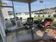 Cozy screened porch with wicker furniture, perfect for outdoor relaxation and entertaining at 8164 Forest Edge Dr., Myrtle Beach, SC 29579
