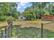 Large, fenced backyard with mature trees, a storage shed, and ample grassy space at 823 Bellamy Ave., Murrells Inlet, SC 29576