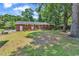 A well-maintained yard features a brick home and lush mature trees in a serene setting at 823 Bellamy Ave., Murrells Inlet, SC 29576