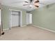 Cozy bedroom with a closet featuring neutral walls, carpet flooring, and a ceiling fan for comfortable living at 823 Bellamy Ave., Murrells Inlet, SC 29576