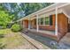 Inviting brick home featuring a classic front porch with white columns at 823 Bellamy Ave., Murrells Inlet, SC 29576