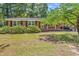 Charming brick home featuring a well-maintained front yard and covered carport at 823 Bellamy Ave., Murrells Inlet, SC 29576