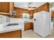 Well-lit kitchen with wood cabinets and white countertops at 823 Bellamy Ave., Murrells Inlet, SC 29576