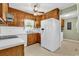 Spacious kitchen featuring wood cabinetry and modern white appliances at 823 Bellamy Ave., Murrells Inlet, SC 29576
