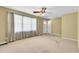 Bright living room featuring large windows and a ceiling fan, perfect for relaxation and entertaining at 823 Bellamy Ave., Murrells Inlet, SC 29576