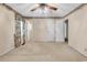 Spacious main bedroom with floral wallpaper border, carpet, and a ceiling fan at 823 Bellamy Ave., Murrells Inlet, SC 29576
