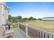 Relax on this beautiful deck with chairs and table overlooking green space and blue sky at 8468 Duke Pl. # 28, Myrtle Beach, SC 29572