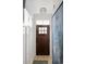 Charming entryway with wood door, modern light fixture, white wainscotting and neutral rug at 8468 Duke Pl. # 28, Myrtle Beach, SC 29572