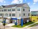 Well-maintained three-story townhome with a brick foundation, manicured lawn and inviting entryway at 8468 Duke Pl. # 28, Myrtle Beach, SC 29572