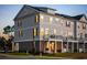 Cozy three-story townhome with balcony seating, and warm interior lights in a tranquil setting at 8468 Duke Pl. # 28, Myrtle Beach, SC 29572