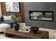 Close up of a modern fireplace with a stylish gray tile surround and wood accent wall at 8468 Duke Pl. # 28, Myrtle Beach, SC 29572
