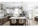 Bright kitchen with stainless appliances, white cabinetry, large island, and designer lighting at 8468 Duke Pl. # 28, Myrtle Beach, SC 29572
