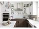 Modern kitchen with stainless steel appliances, white cabinets, large island and designer lighting at 8468 Duke Pl. # 28, Myrtle Beach, SC 29572