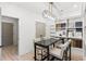 Living room featuring custom cabinetry, a modern chandelier, and a large table at 8468 Duke Pl. # 28, Myrtle Beach, SC 29572