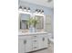 Elegant bathroom featuring double vanity with marble countertop and modern fixtures at 8470 Duke Pl. # 29, Myrtle Beach, SC 29572