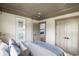 Cozy bedroom with neutral color scheme, large windows, and a view into another room at 8470 Duke Pl. # 29, Myrtle Beach, SC 29572
