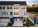 Inviting three-story townhome with warm interior lights, set against a twilight sky and landscaped frontage at 8470 Duke Pl. # 29, Myrtle Beach, SC 29572